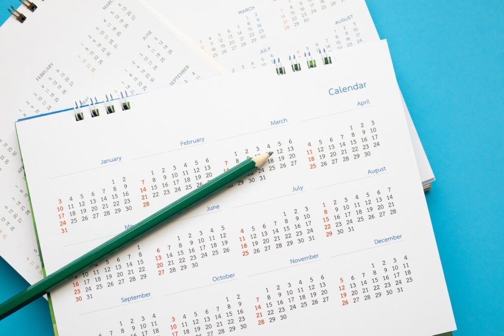 A calendar with a pencil on it to represent someone planning their weight loss treatment schedule. They have been researching 'Can You Skip a Week of Wegovy or Mounjaro?'