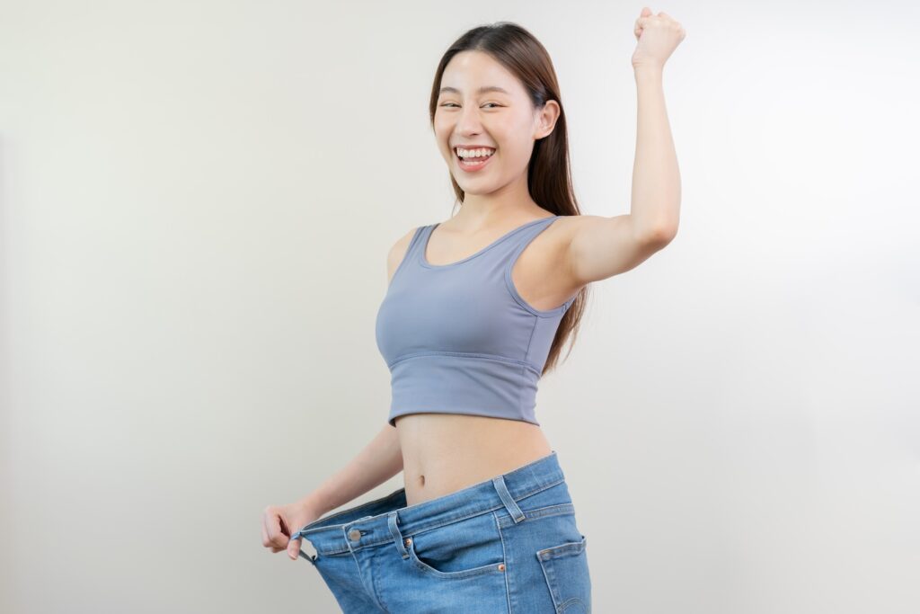 A woman who has lost weight, celebrating, because of the mounjaro maintenance dose