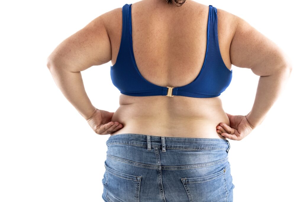 A woman holding her hips, wondering what happens when you stop taking Mounjaro