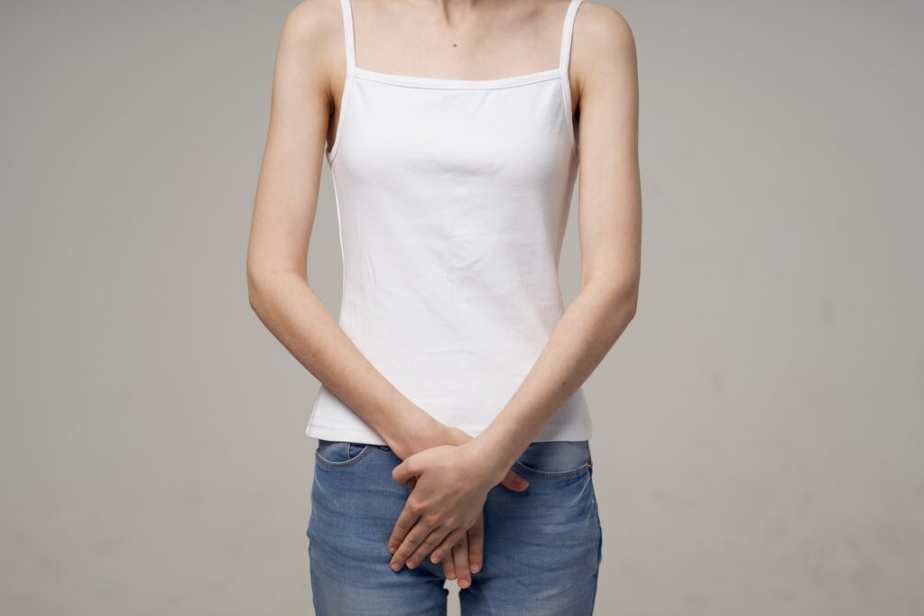 A woman with her hands crossed over her crotch to represent ‘How to Treat Thrush’