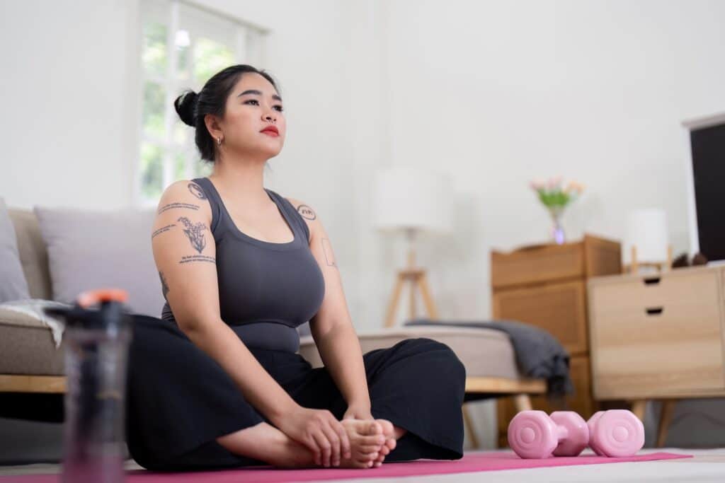 A woman sat practicing yoga thinking about how to stop taking wegovy