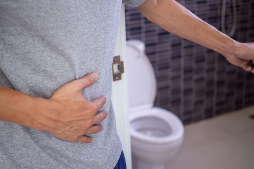 Best Weight Loss Tablets A Man Holding His Stomach Next To A Toilet Suffering From Mounjaro Side Effects